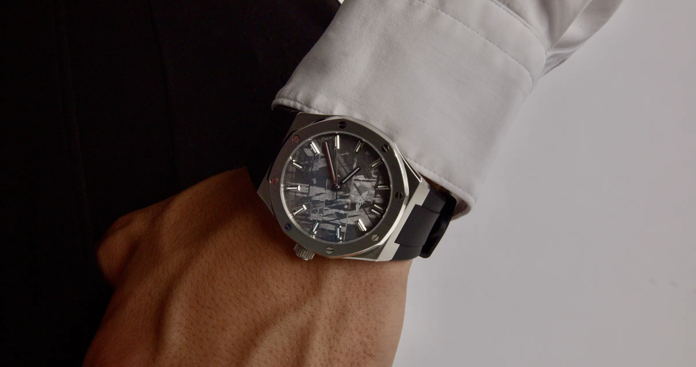 The Visto at a white shirt cuff against dark trousers.